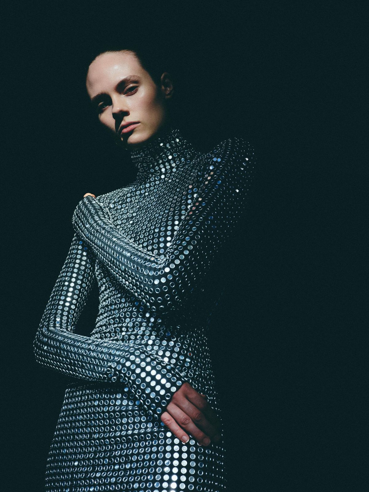 Model in a mirrored-disc chainmail gown